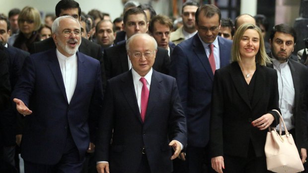 Iranian Foreign Minister Mohammad Javad Zarif, left, IAEA Director Yukiya Amano and EU High Representative Federica Mogherini, right, arrive at the IIAEA, in Vienna, on Saturday. 