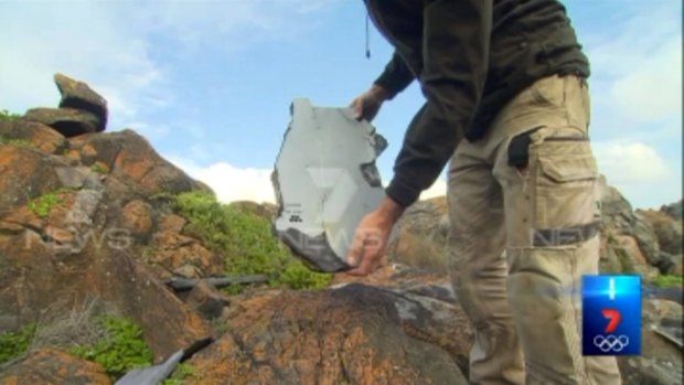 Samuel Armstrong holds a piece of debris he found on Kangaroo Island in South Australia.