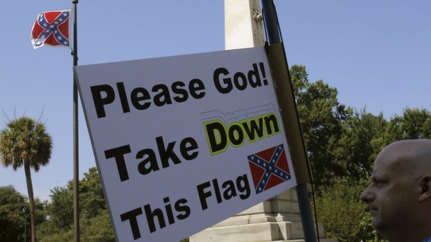 A demonstrator holds a sign at a rally in South Carolina demanding the removal of the Confederate flag.