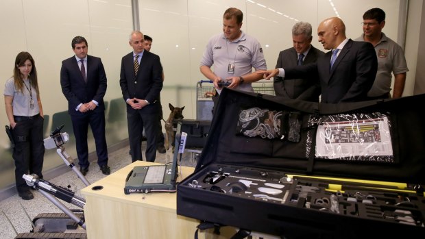 Brasilia Governor Rodrigo Rolemberg, third right, and Justice Minister Alexandre de Moraes, second right, at a Brasilia airport security briefing.