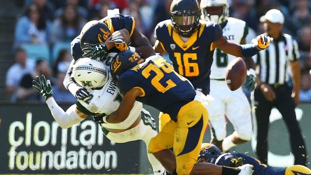 Crunch time: Hawaii's Keelan Ewaliko is tackled during the College Football Sydney Cup match against University of California.