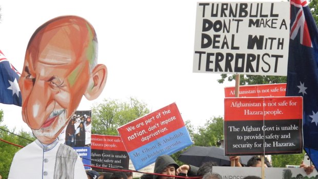 Demonstrators with a cutout of Afghan President Ashraf Ghani protest against his visit to Australia outside Government House, where Dr Ghani met with Governor-General Peter Cosgrove.