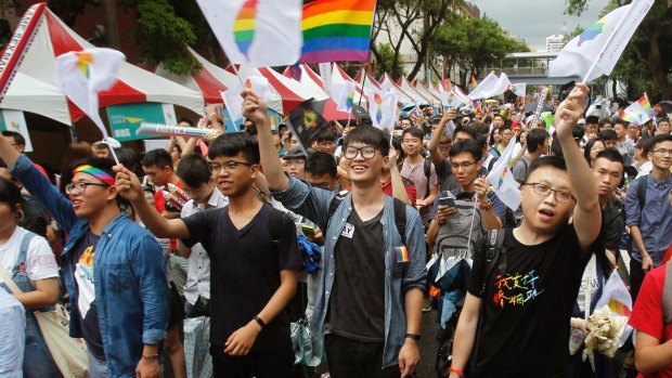 Same-sex marriage supporters cheer after Taiwan's Constitutional Court ruled in favour of same-sex marriage.