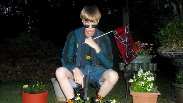 Dylann Roof posing for a photo while holding a Confederate flag: an undated image that appeared on Lastrhodesian.com, a website investigated by the FBI in connection with Charleston shootings. 