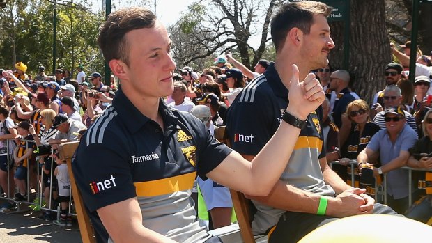 Billy Hartung waves to the crowd during the grand final parade.