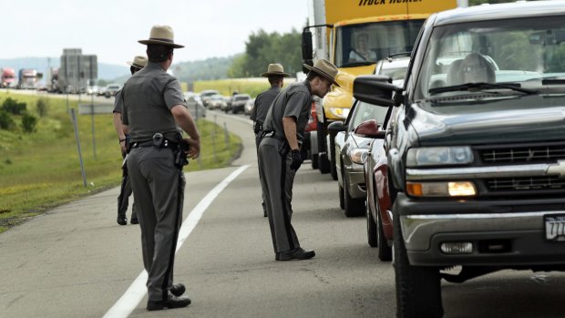 New York state troopers check cars and passengers leaving Route 86 near Friendship, New York, where there was a possible sighting of the escapees. 