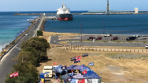 The MV Portland moored at Portland's Lee breakwater, supported by a protest camp in the foreground. 