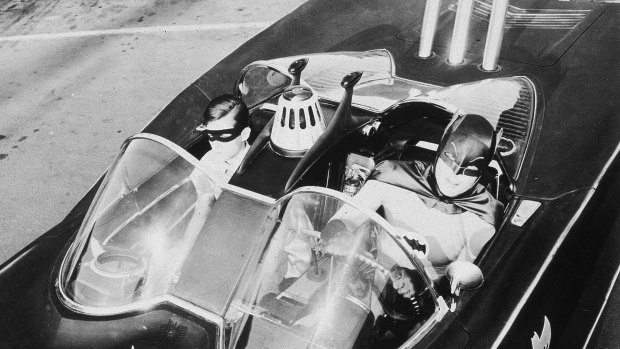 American actors Burt Ward (left), as Robin, and Adam West, as Batman, ride in the Batmobile in a still from the television series, c1967.