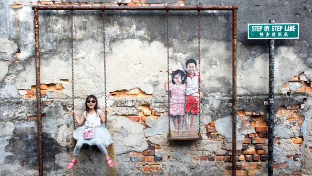 'Children on the Swing' street art by local artist Louis Gan in George Town, Penang, Malaysia.