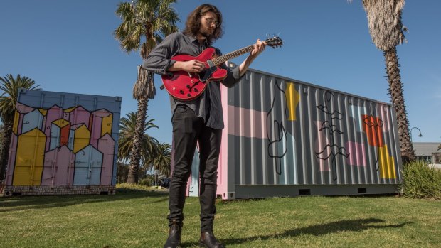Blues guitarist Boadz plays around the shipping containers on the foreshore. 