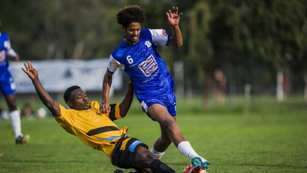 Osman Fofanah of the Tigers and Olympic's Jeremy Habtemariam clash at O'Connor Oval.