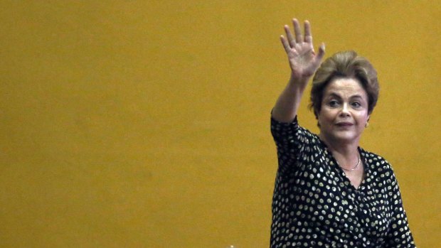 Brazilian President Dilma Rousseff waves as she arrives to speak at a women's rights conference on May 10.