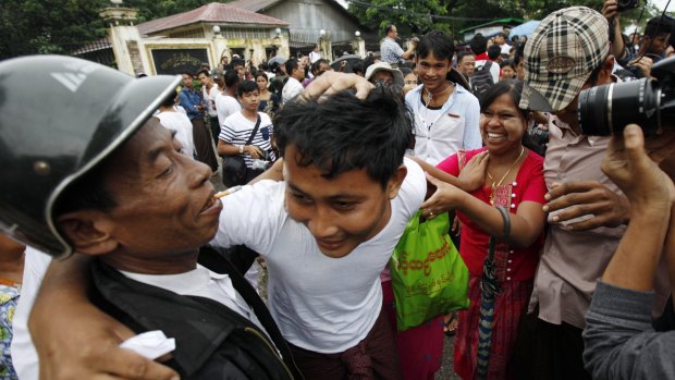 A released prisoner, centre, is welcomed by his family outside Insein Prison in Yangon on Thursday.