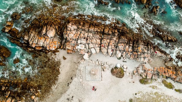 Aerial view of rocks and breaking waves at Cape Agulhas, South Africa's southern-most point. 