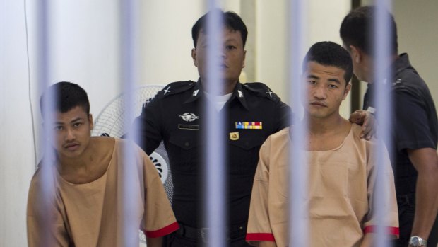 Myanmar workers Win Zaw Htun, right, and Zaw Lin, left, both 22, escorted by officials after they were convicted in December last year of the murder Hannah Witheridge and David Miller. 