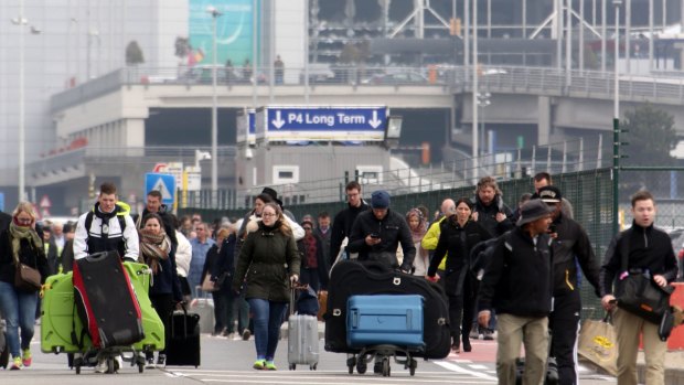 Passengers are evacuated from Brussels airport after the blast on Tuesday morning. 