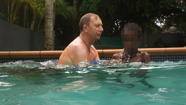 Gregory James Druery in the pool with children in Vanuatu in 2013 after he posed as a Salvation Army member.