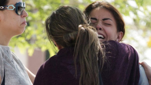 Relatives of those on board EgyptAir flight MS804 comfort each other outside Cairo International Airport.