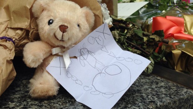 A soft toy with a child's drawing at the Bourke Street memorial.