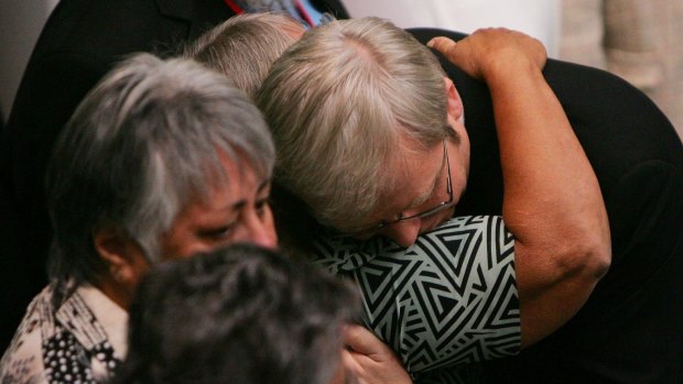 Prime minister Kevin Rudd hugs Indigenous guests after his apology on 13 February, 2008. 