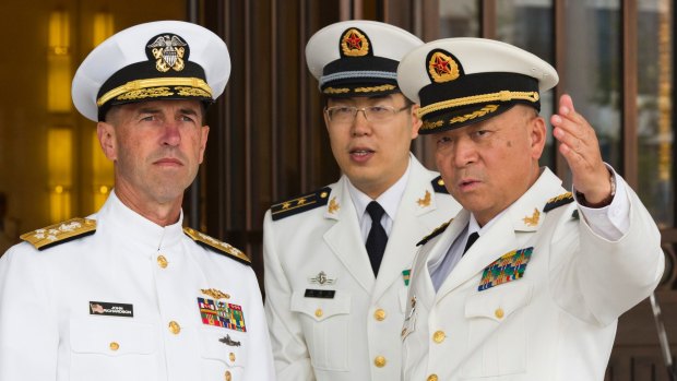 US Chief of Naval Operations Admiral John Richardson, left, listens to Commander of the Chinese Navy Admiral Wu Shengli, right, at Chinese Navy Headquarters in Beijing in 2016.