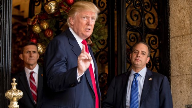 Then president-elect Donald Trump accompanied by chief of staff Reince Priebus, right, and retired general Michael Flynn in December.