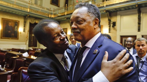 South Carolina Representative Carl Anderson left, embraces Reverend Jesse Jackson after the House approved a bill removing the Confederate flag from the Capitol grounds in South Carolina.