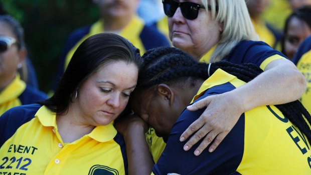 Kim Bartlett, left, comforts Cassandra Johnson before a funeral for their coworker Erick Silva, a security guard killed in the Las Vegas shooting.