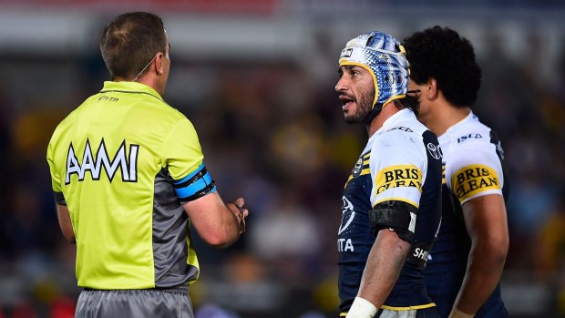 Stop-start affair: Johnathan Thurston speaks with referee Ben Cummins during the loss to the South Sydney Rabbitohs at 1300SMILES Stadium in Townsville.