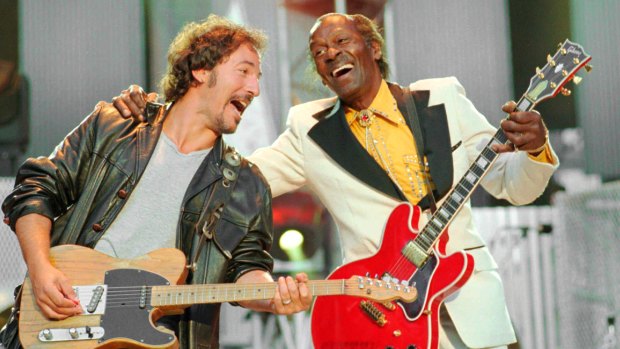 Bruce Springsteen, left , and Chuck Berry laugh during the performance of the Berry hit <i>Johnny B. Goode</i> at the Concert for the Rock and Roll Hall of Fame in Cleveland in 1995.