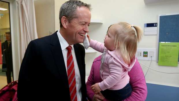 Bill Shorten gets his temperature checked by 20-month-old Katie Plowman at Casey Hospital in Berwick.