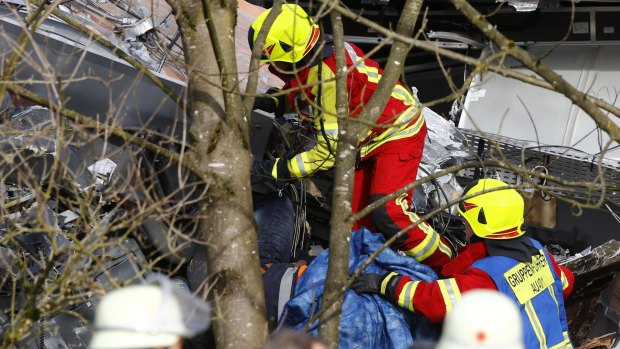 Rescue workers retrieve a body at the site where two trains collided head-on near Bad Aibling, southern Germany, on Tuesday.