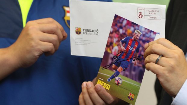 Democracy party member Howard Lam displays a photo of soccer star Lionel Messi during a press conference in Hong Kong.