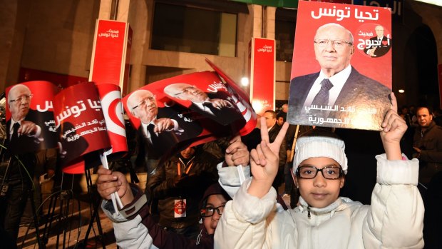 Supporters of former Tunisian prime minister and presidential candidate Beji Caid Essebsi celebrate after claims of victory.