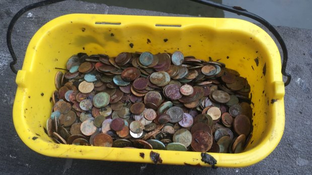 One of the buckets of coins retrieved from the fountain outside the National Gallery of Victoria. 