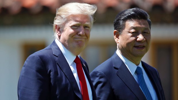 Donald Trump and Chinese President Xi Jinping walk together after their meetings at Mar-a-Lago in Florida.