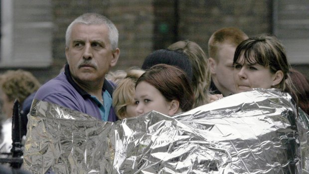 Londoners wrapped in emergency blankets after the explosion in Tavistock Square, in London. 