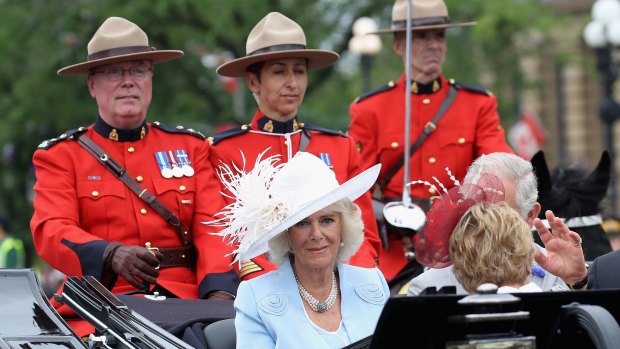 Camilla, Duchess of Cornwall and Prince Charles arrive on Parliament Hill escorted by officers of the Royal Canadian Mounted Police.
