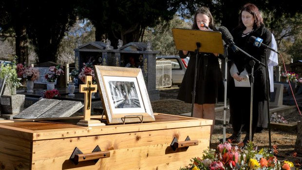 Val Jeffery's grand-daughters Madelaine and Charlotte give a reading at his funeral. Mr Jeffery's coffin was made by Tharwa furniture maker Myles Gostelow, with the metal parts from the original Tharwa bridge. 