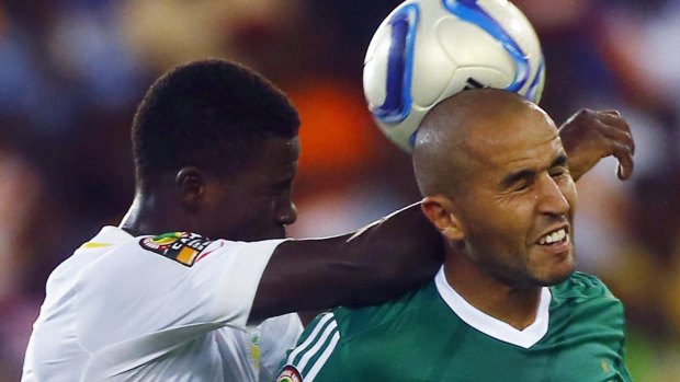 Senegal's Mison Djilobodji (left) competes for the ball with Madjid Bouguerra.