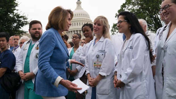 House Minority leader Nancy Pelosi  is joined by health care workers  protesting Republican health proposals outside the Capitol.