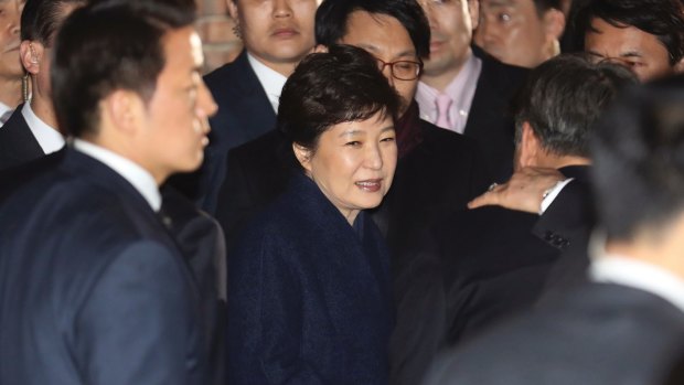 Park Geun-hye, center, arrives at her private home in Seoul.