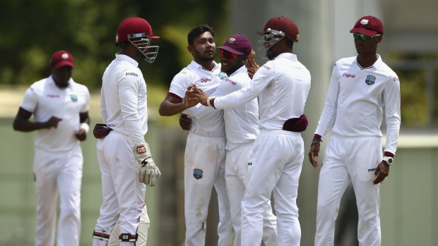 Devendra Bishoo of the West Indies celebrates after taking the wicket of Brad Haddin.