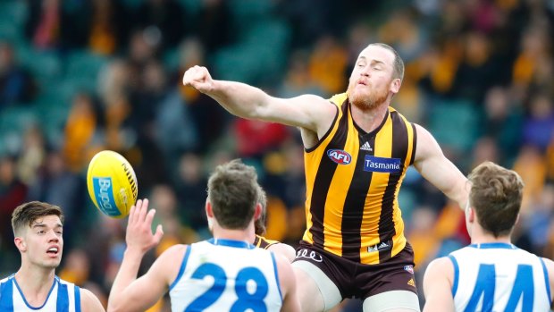 Over and above: Hawthorn's Jarryd Roughead clears through the pack.