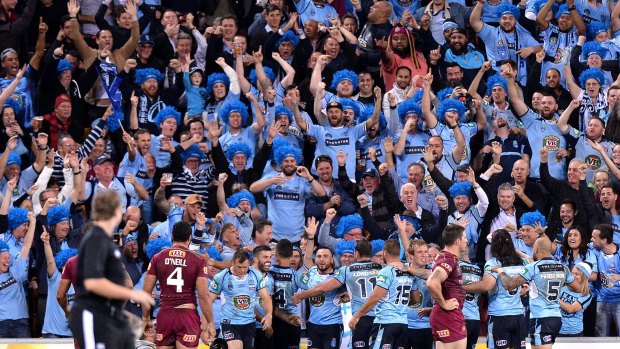 Blue murder: NSW fans celebrate with their heroes in Brisbane.