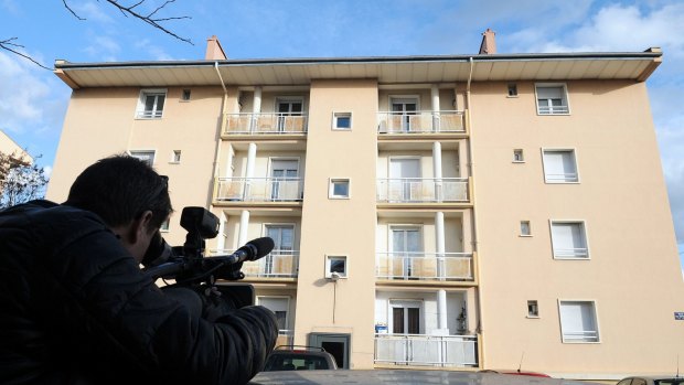 A man films a building in Beziers, where a Russian Chechen suspected of preparing a terrorist attack was living before his January 19 arrest. 