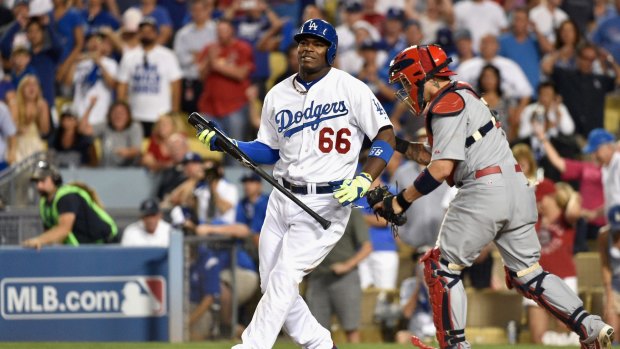 Yasiel Puig of the Los Angeles Dodgers strikes out swinging with the tying run on third base for the last out of Game One of the National League Division Series against the St Louis Cardinals at Dodger Stadium on October 3, 2014 in Los Angeles.