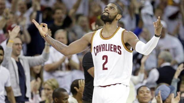 Young blood: Cleveland star Kyrie Irving celebrates after making a three-point shot at the buzzer to end the second quarter.