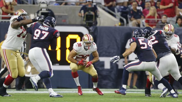 Switching codes: Jarryd Hayne rushes during last year's pre-season game against the Houston Texans.