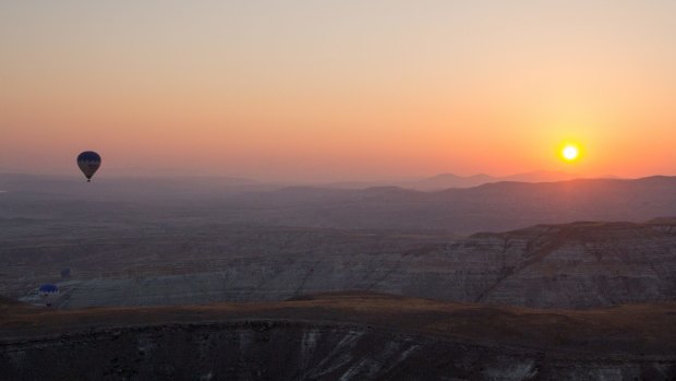 Watching the sunrise from a hot air balloon in  Cappadocia.